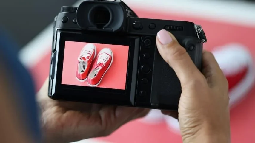 A camera display showing a photograph of real shoes.